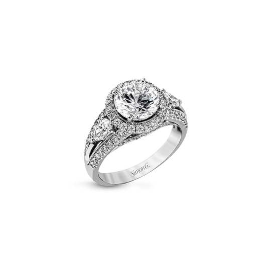 Elegant white gold three-stone diamond engagement ring with a large round center stone, flanked by smaller diamonds on a detailed band.