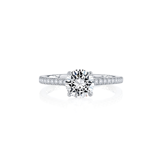 A white gold Art Deco engagement ring featuring a large round diamond centerpiece with a band adorned with smaller diamonds.