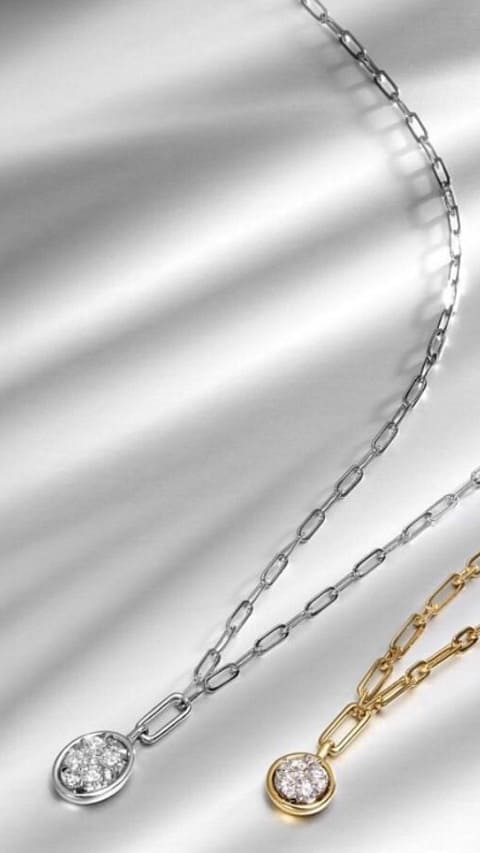Silver and gold necklaces with diamond center stones
