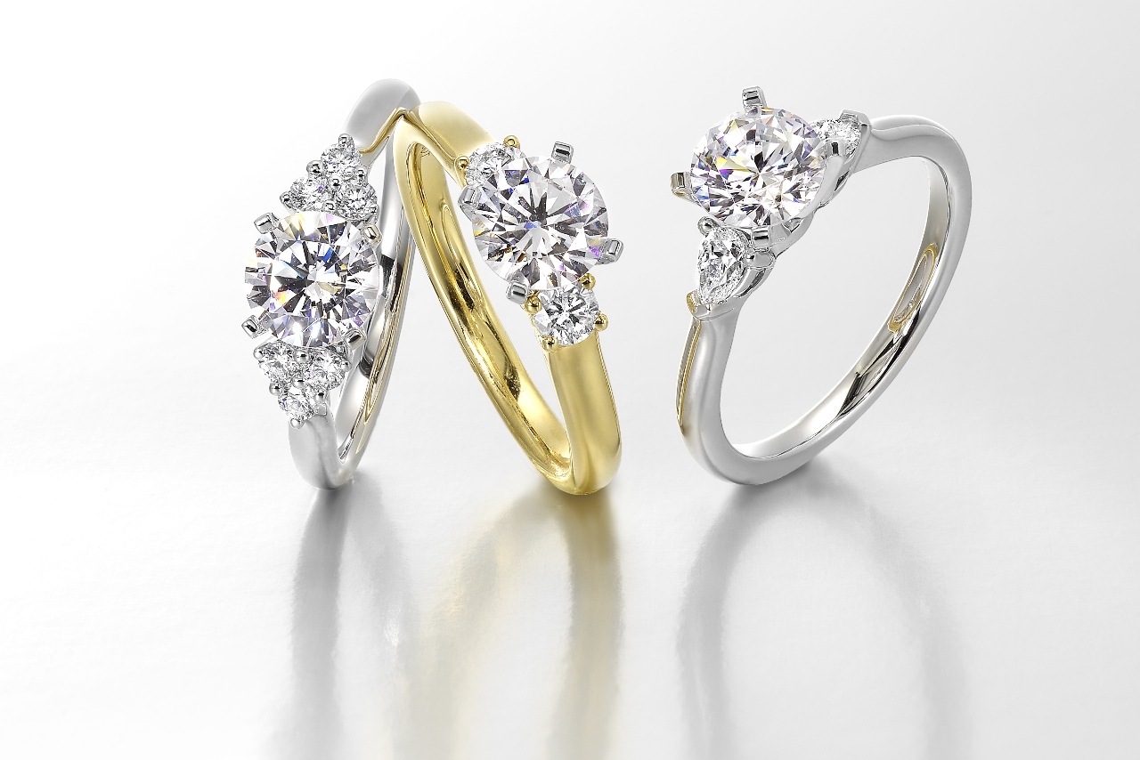Three different three stone diamond engagement rings available at Huntington Fine Jewelers