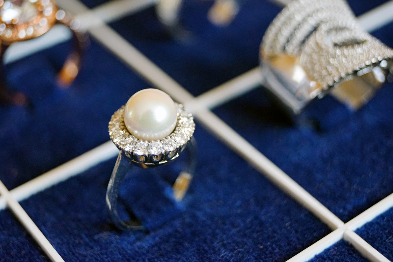 A blue-velvet display case holding beautiful rings of different metals.