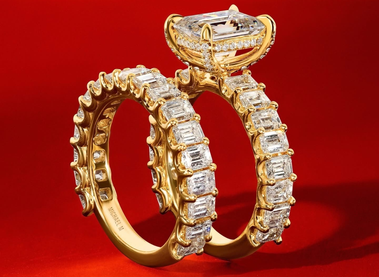 A wedding band and engagement ring with emerald cut diamonds along the bands of each A wedding band and engagement ring with emerald cut diamonds along the bands of each