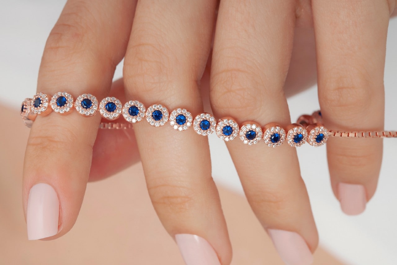 a rose gold bracelet featuring sapphire and diamonds a rose gold bracelet featuring sapphire and diamonds