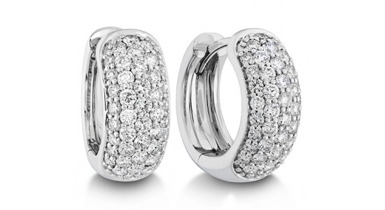 A pair of chunky white gold huggie earrings with pavé-set diamonds from Memoire, available at Huntington Fine Jewelers.