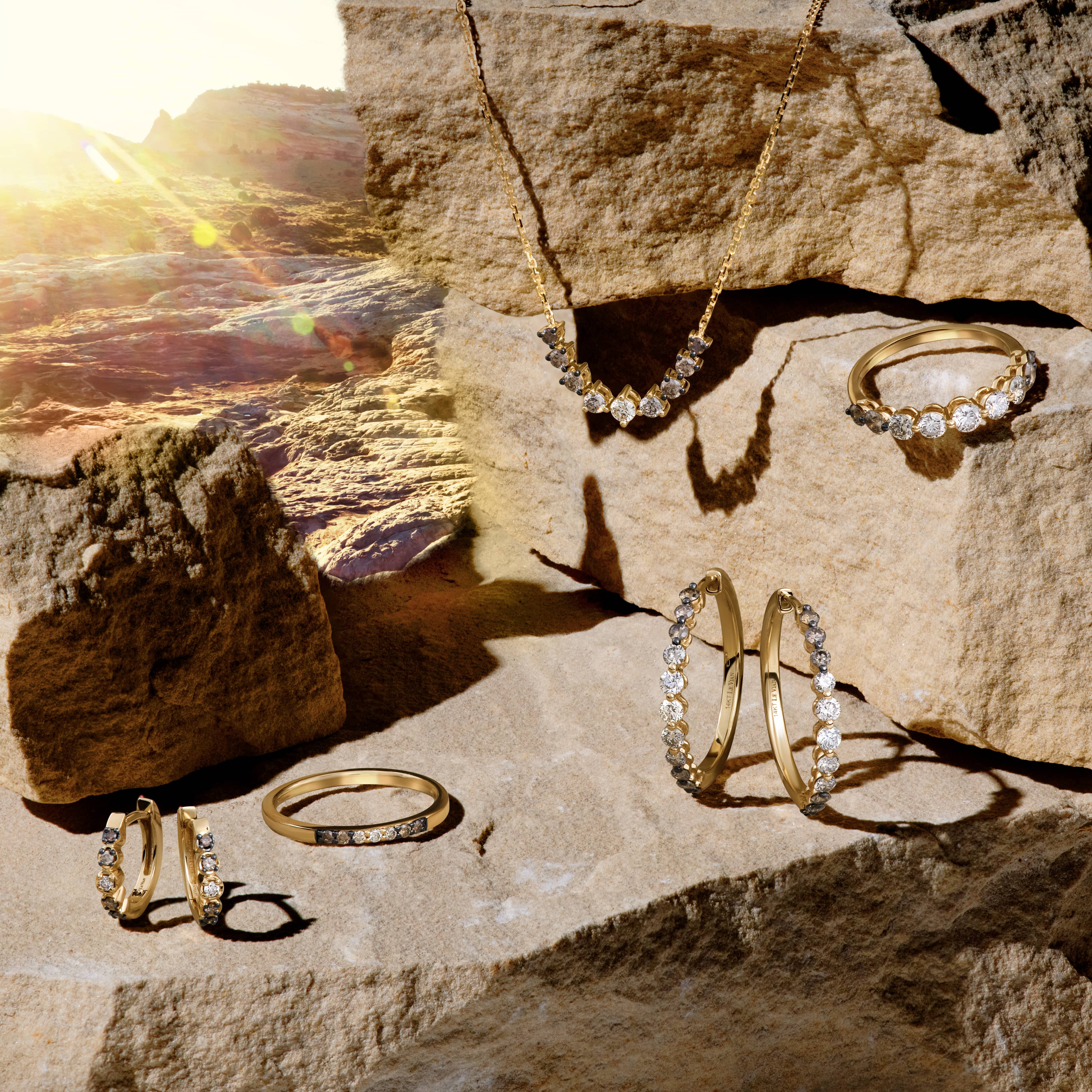 A close-up of a woman's hand, adorned with three delicate gold fashion rings.