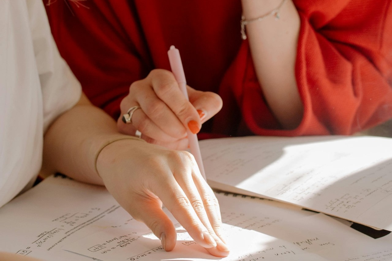 A jeweler working alongside a customer on a custom jewelry design. A jeweler working alongside a customer on a custom jewelry design.