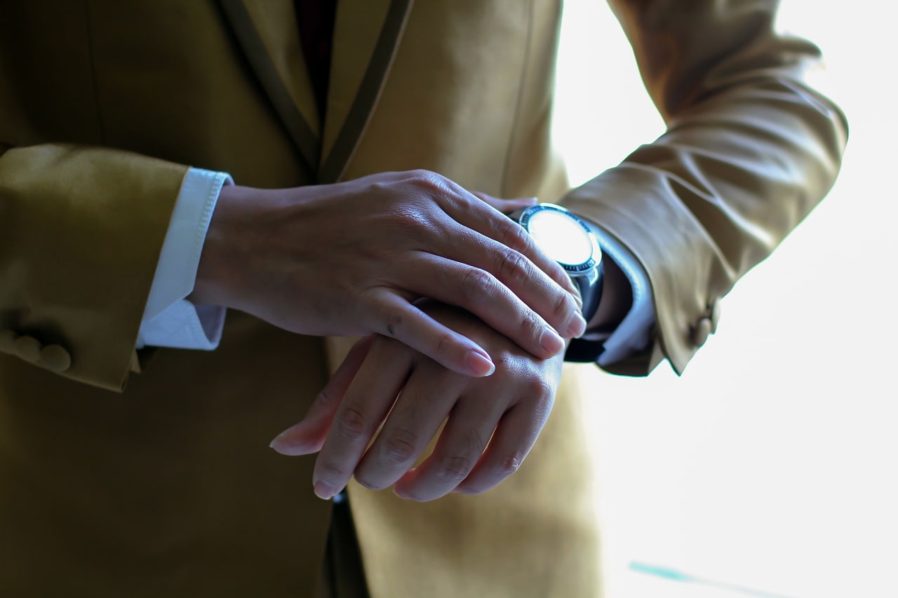 glare on timepiece on man in suit glare on timepiece on man in suit