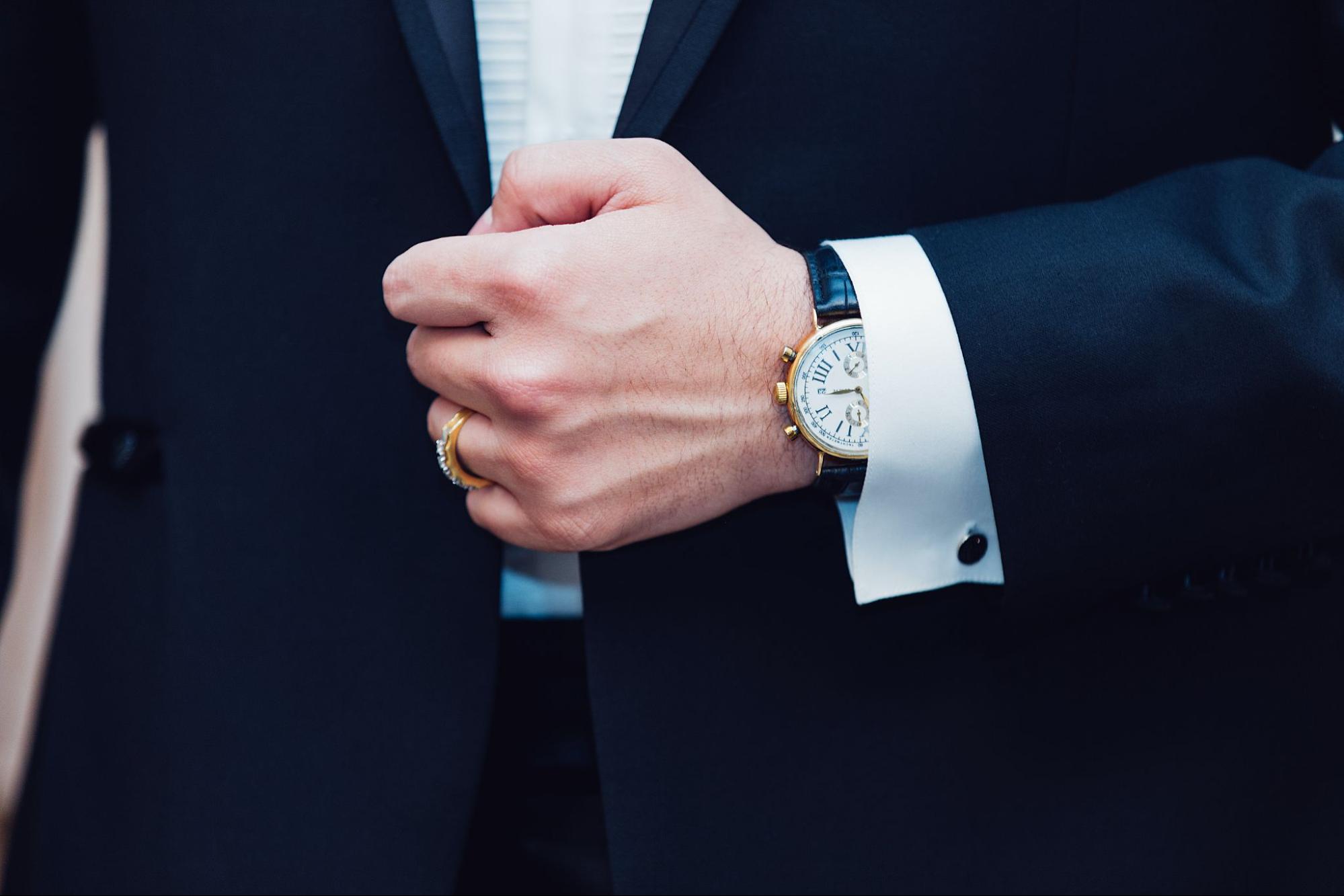 A man wearing a suit with a matching luxury watches A man wearing a suit with a matching luxury watches
